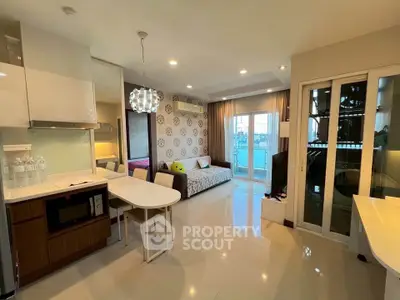 Modern open-layout living room with stylish decor and balcony view in a contemporary apartment.