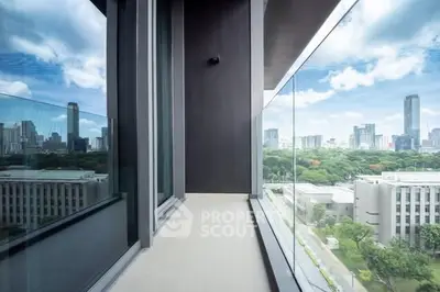 Stunning cityscape view from a modern glass balcony in a high-rise building.