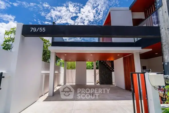 Modern architectural exterior with sleek design and open parking space.