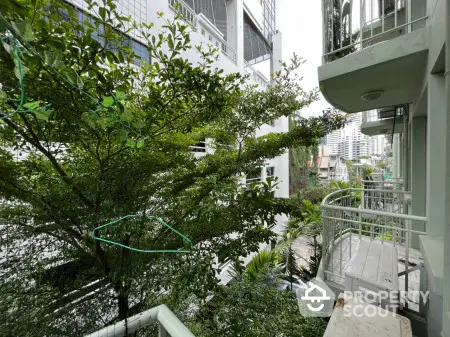 Charming urban balcony with lush greenery and city views, perfect for relaxation and enjoying nature.