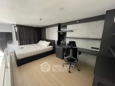 Modern bedroom with sleek desk and comfortable bed in stylish apartment