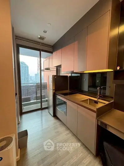 Modern kitchen with sleek cabinetry and balcony view in high-rise apartment