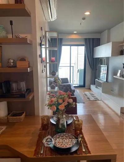 Charming living room with balcony, stylish decor, and natural light, perfect for relaxation and entertaining.
