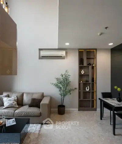 Modern living room with stylish decor and open layout, featuring a cozy sofa and elegant dining area.