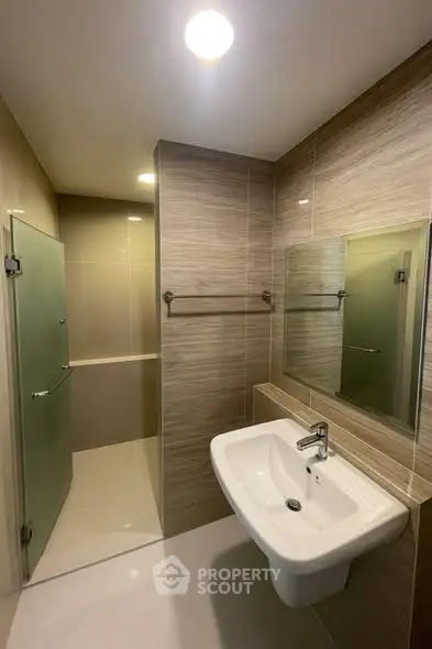 Modern bathroom with sleek sink and glass shower enclosure