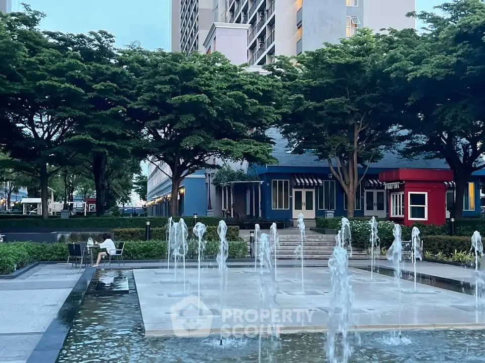 Charming urban courtyard with water fountains and lush greenery, perfect for relaxation and leisure.