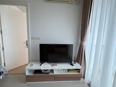 Modern living room with sleek TV stand and large window curtains