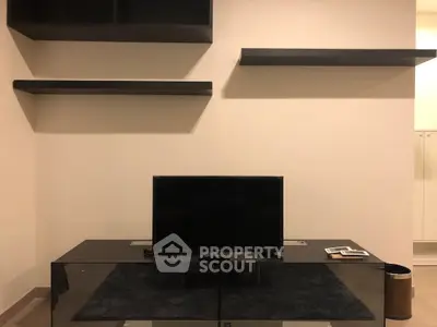Modern living room with sleek TV stand and minimalist wall shelves, perfect for contemporary living.