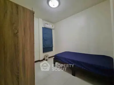 Cozy minimalist bedroom with single bed and air conditioning