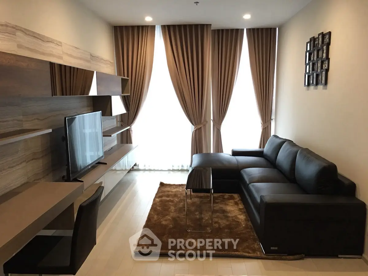 Modern living room with sleek black sofa and stylish shelving