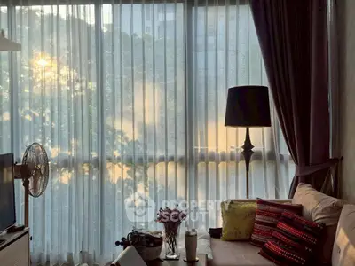 Cozy living room with soft sunlight filtering through sheer curtains, elegant decor and comfortable seating.