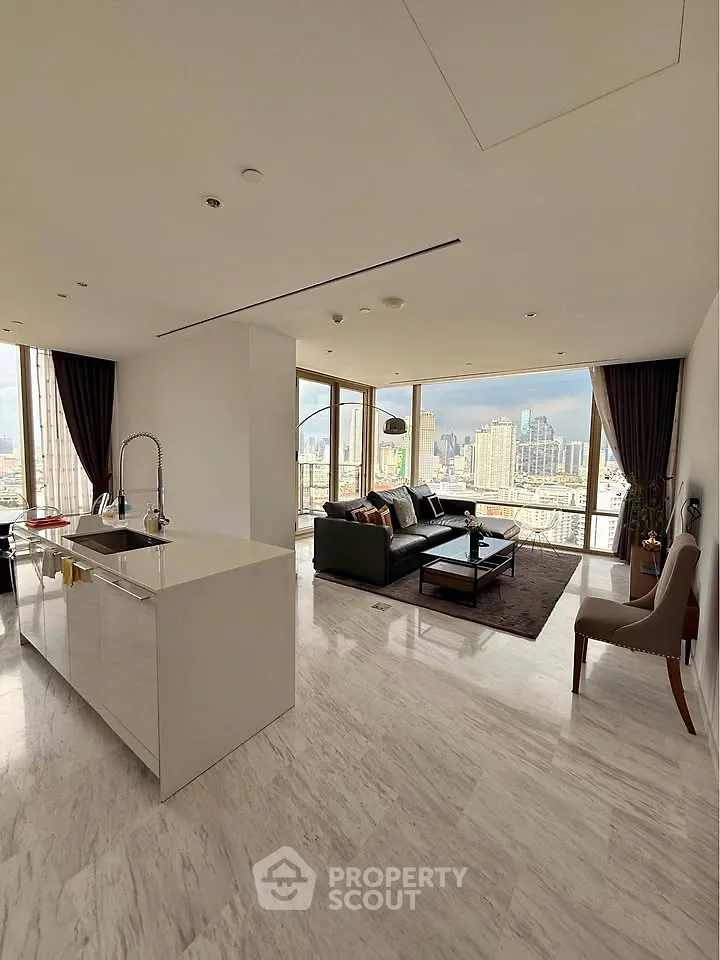 Luxurious open-plan living room with stunning city views and modern kitchen island.