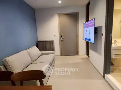 Modern living room with cozy sofa and wall-mounted TV, perfect for relaxation.