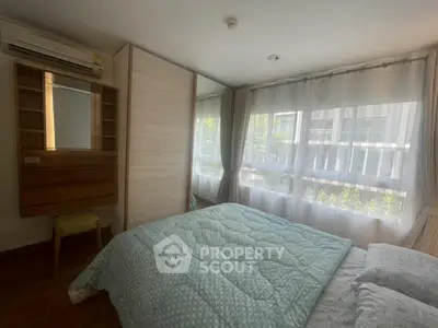 Cozy bedroom with large windows and modern decor in a bright apartment