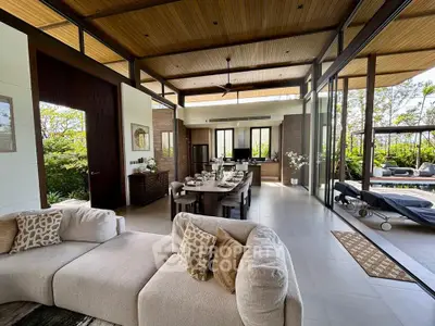 Luxurious open-plan living room with elegant decor and stunning garden views, perfect for modern living.
