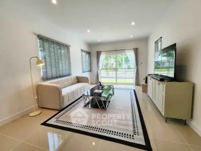 Spacious modern living room with elegant decor and large windows
