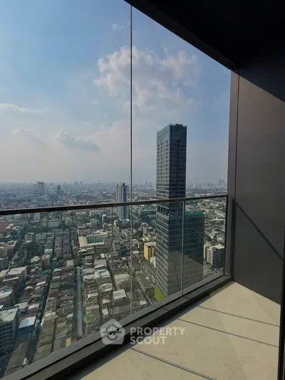 Stunning high-rise balcony view overlooking cityscape with modern skyscrapers and expansive skyline.