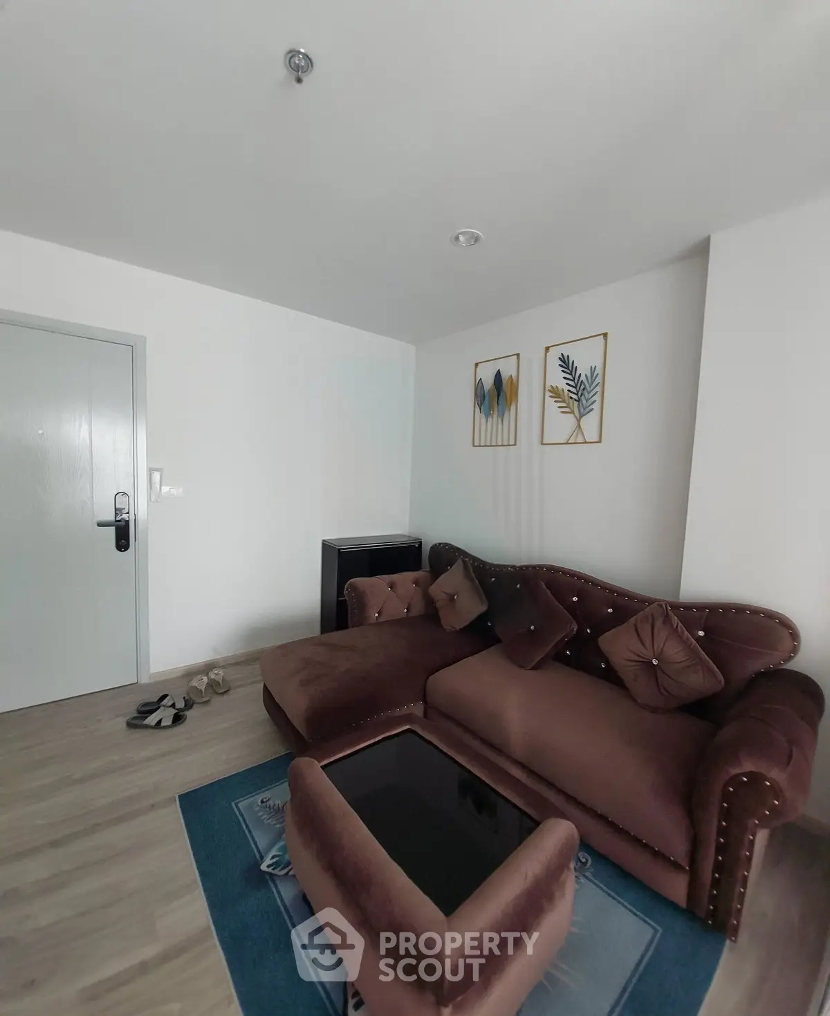 Cozy living room with plush brown sofa and modern decor in a stylish apartment.