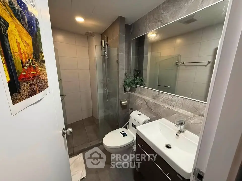 Modern bathroom with sleek fixtures and glass shower enclosure