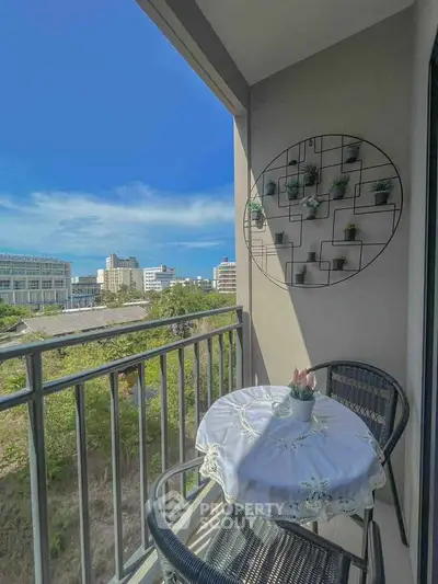 Charming balcony with city view and cozy seating area