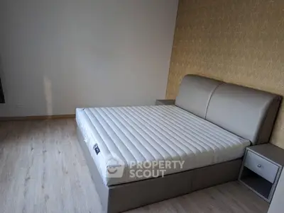 Modern bedroom with stylish bed and elegant wallpaper, perfect for a cozy retreat.