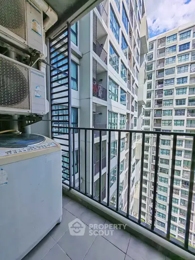 High-rise apartment balcony with city view and washing machine
