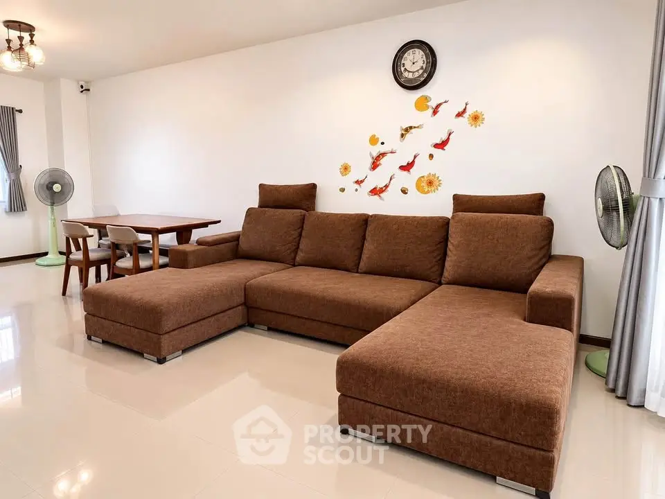 Spacious living room with modern brown sectional sofa and elegant wall decor
