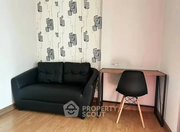 Cozy living room with modern black sofa and stylish desk setup