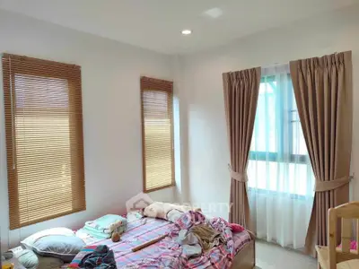 Cozy bedroom with natural light and stylish window treatments