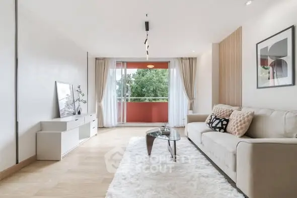 Spacious modern living room with elegant decor and large balcony view.