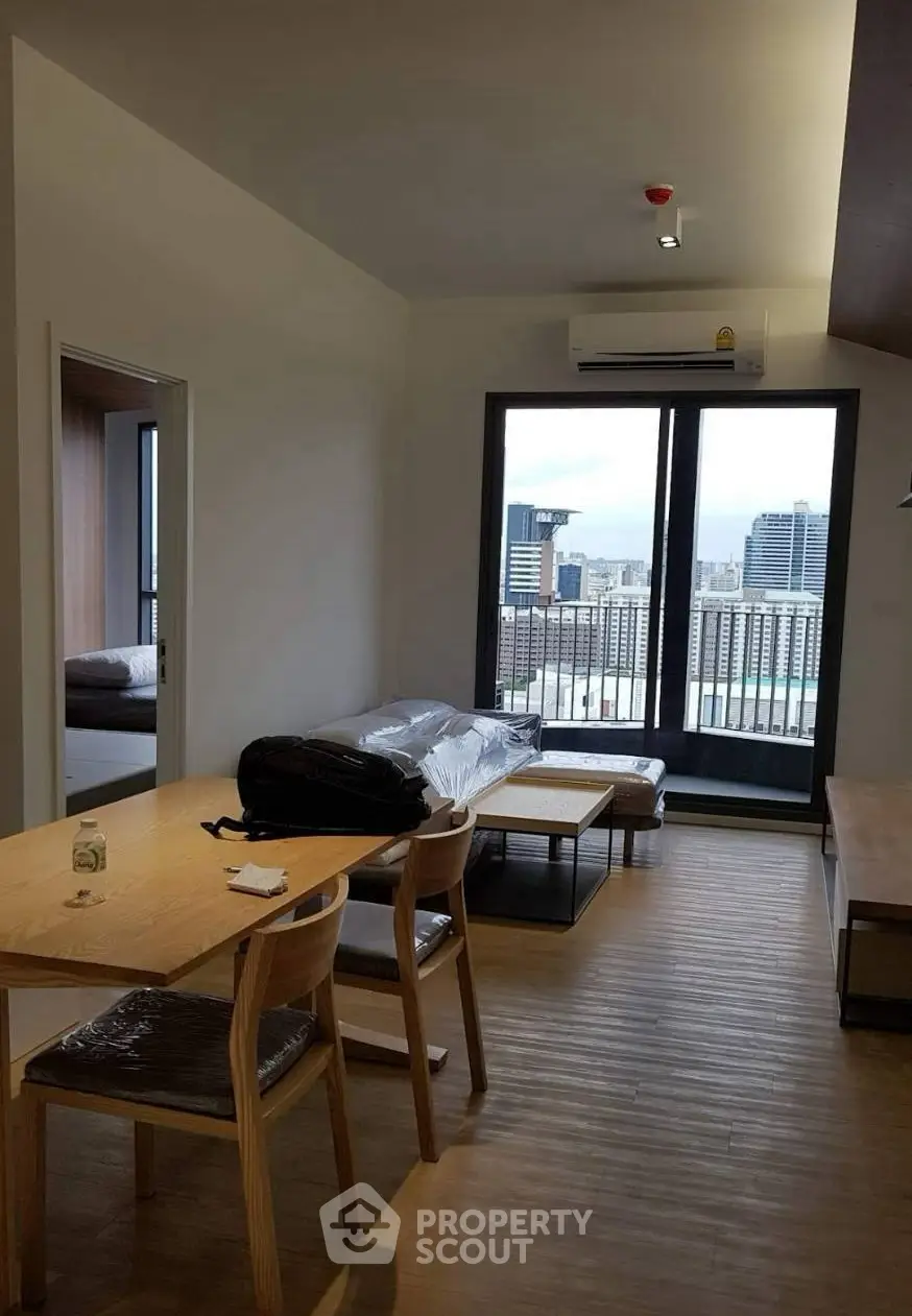 Modern living room with city view and balcony access