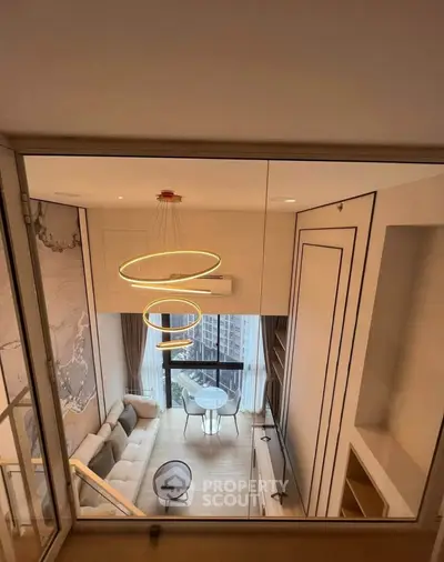 Modern loft-style living room with high ceilings and stylish lighting in a luxury apartment.