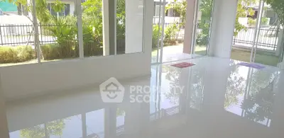 Spacious living room with large windows and garden view, perfect for natural light lovers.