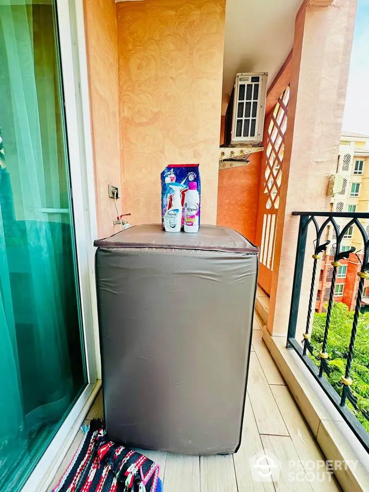 Charming balcony with washing machine and scenic view in modern apartment.