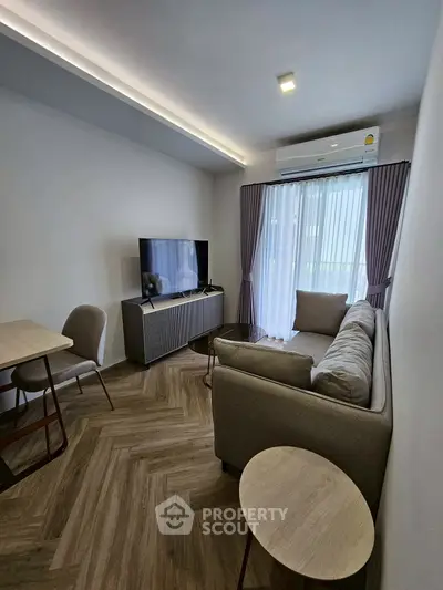 Modern living room with stylish furniture and natural light, perfect for relaxation and entertainment.