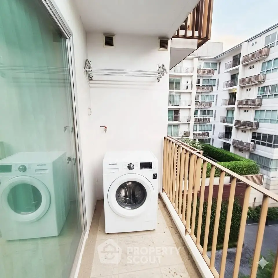 Charming balcony with washing machine in modern apartment complex