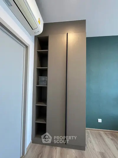 Modern bedroom with sleek built-in wardrobe and air conditioning unit