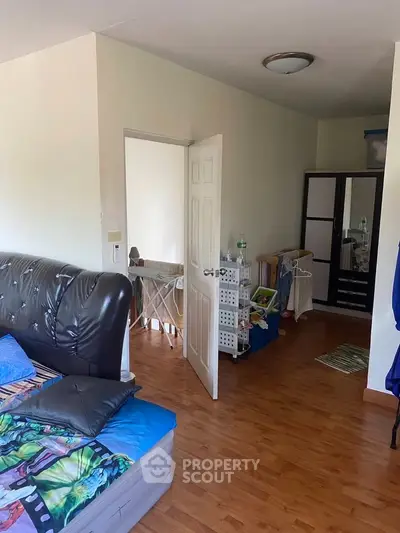 Cozy bedroom with wooden flooring and modern decor