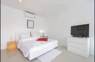 Modern minimalist bedroom with white decor and sleek furniture