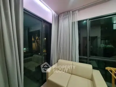 Cozy corner unit with large windows and modern beige sofa in a well-lit living room.