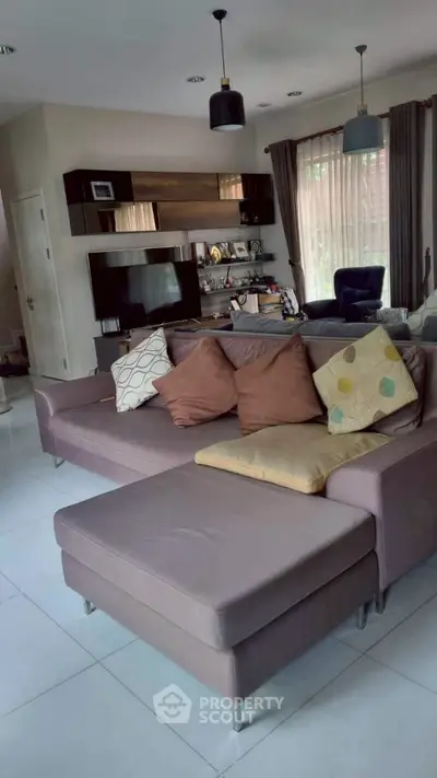Spacious modern living room with stylish sectional sofa and large windows