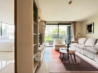 Bright and spacious living room with modern decor and balcony view.