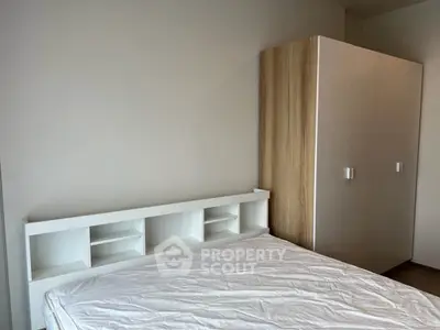 Modern bedroom with sleek wardrobe and minimalist bed frame, perfect for urban living.