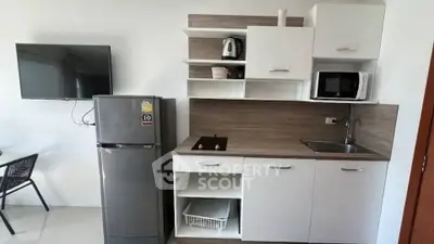 Modern kitchen with sleek appliances and stylish cabinetry in a compact layout.