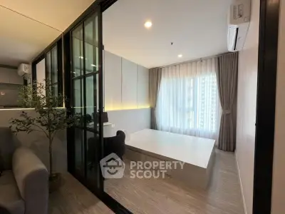 Modern living room with sleek design and large window, featuring stylish furniture and ambient lighting.