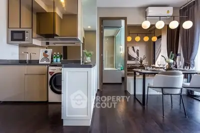 Modern open-plan kitchen and dining area with sleek appliances and stylish decor.