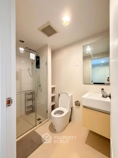 Modern bathroom with glass shower, sleek fixtures, and neutral tones for a clean, contemporary look.