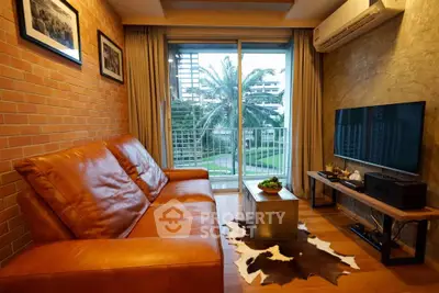 Cozy living room with leather sofa and garden view, perfect for relaxation.