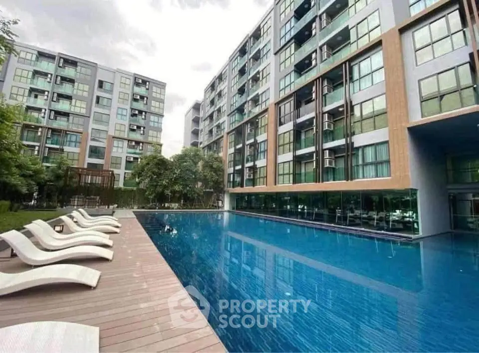 Modern apartment complex with luxurious pool and stylish architecture.