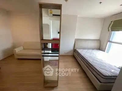 Spacious bedroom with modern furnishings and natural light